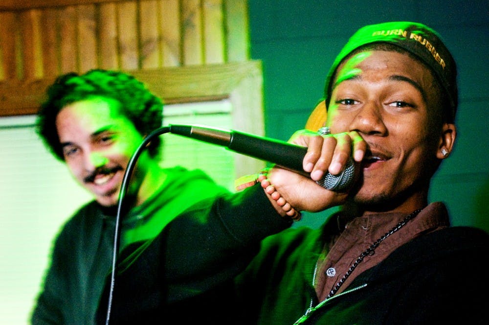 	<p>Detroit resident Tyrell “Young Slapz” Slappey practices his rap at the basement of Phi Gamma Delta at 131 Bogue St Thursday evening after finishing a joke with rap member Sylvester “Johnny Cage” James at the background. The two are part of High Royalty, a group of solo artists who are mostly <span class="caps">MSU</span> Alumni and will perform Friday night in East Lansing.  </p>