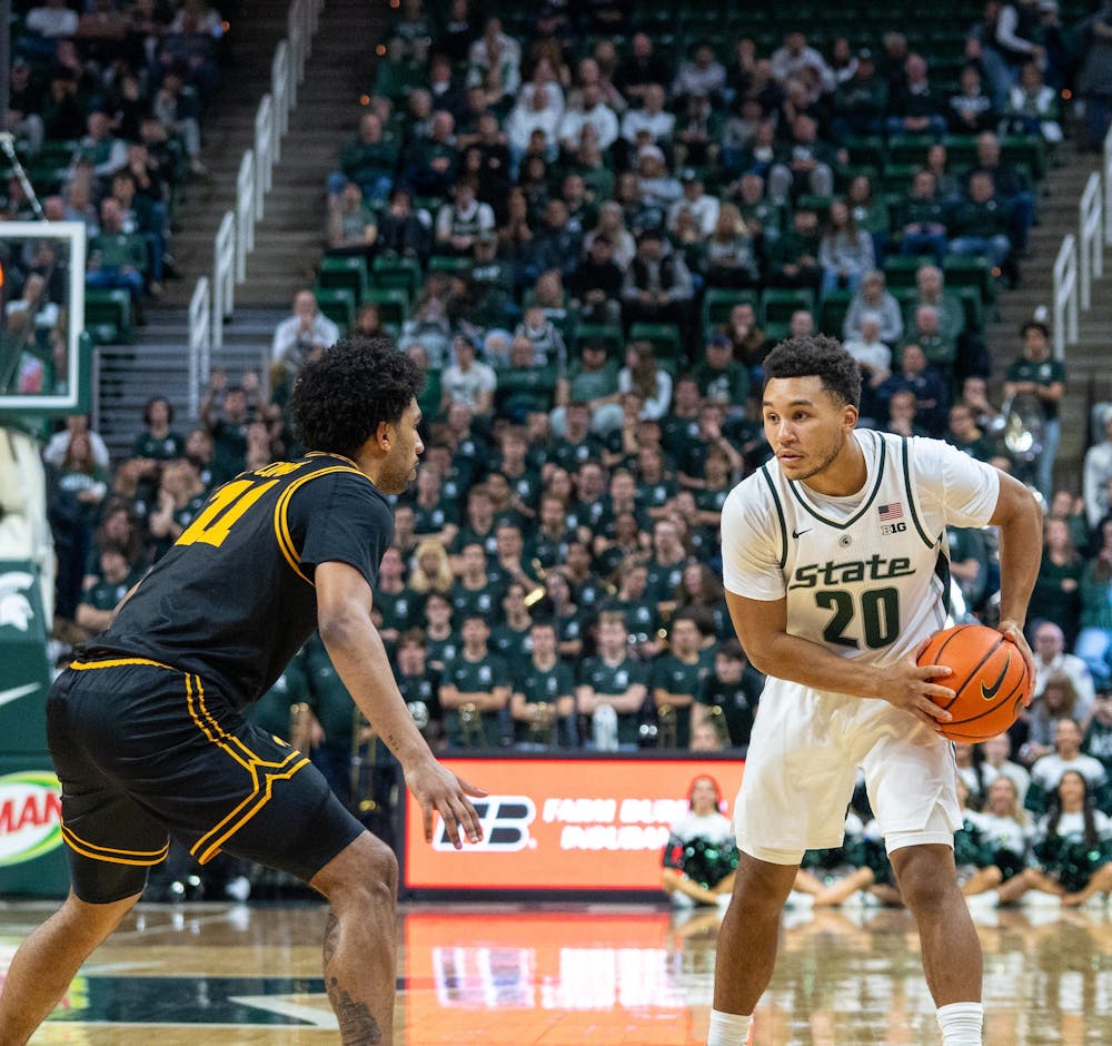 <p>Senior guard Nick Sanders (20) dribbles up the court during the matchup against the University of Iowa at the Breslin Center on Dec. 2, 2025.</p>