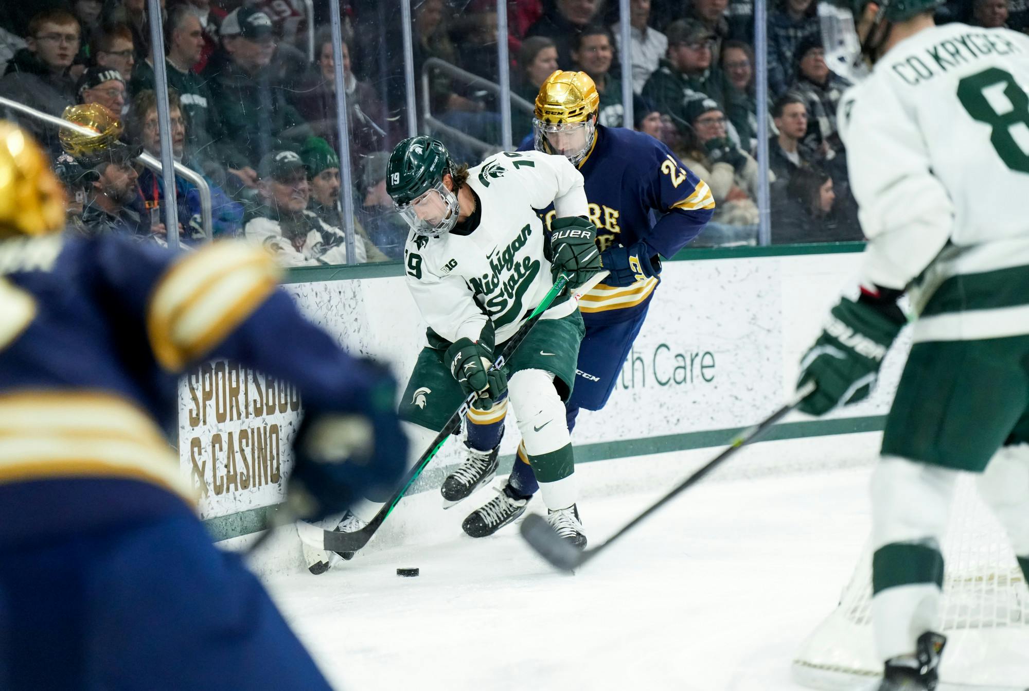 <p>Senior forward Nicolas Müller (19) dribbles the puck during a game against Notre Dame at Munn Ice Arena on Feb. 3, 2023. The Spartans defeated the Fighting Irish 3-0.</p>