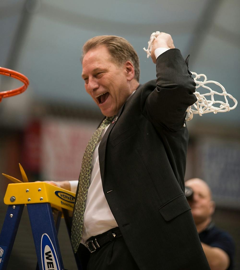 <p>Head coach Tom Izzo cheers after cutting the net March 29, 2015, during the East Regional round of the NCAA Tournament in the Elite Eight against Louisville at the Carrier Dome in Syracuse, New York. The Spartans defeated the Cardinals in overtime, 76-70. Erin Hampton/The State News</p>