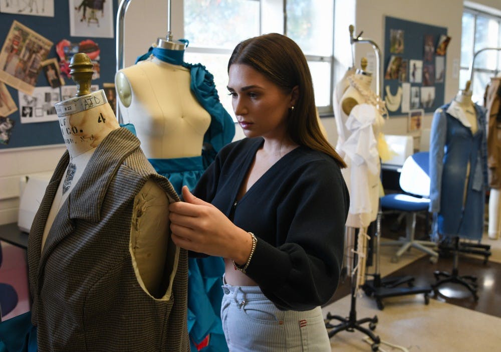 <p>Apparel and textile design major and MSU senior Mikayla Frick works in her studio at the Urban Planning and Landscape Architecture building on October 15, 2019. </p>