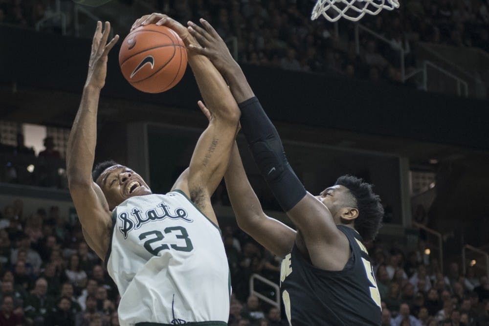 Sophomore forward Xavier Tillman (23) reaches for a rebound during the first half of the men's basketball game against Purdue on Jan. 8, 2018 at Breslin Center. The Spartans led the first half, 39-26.