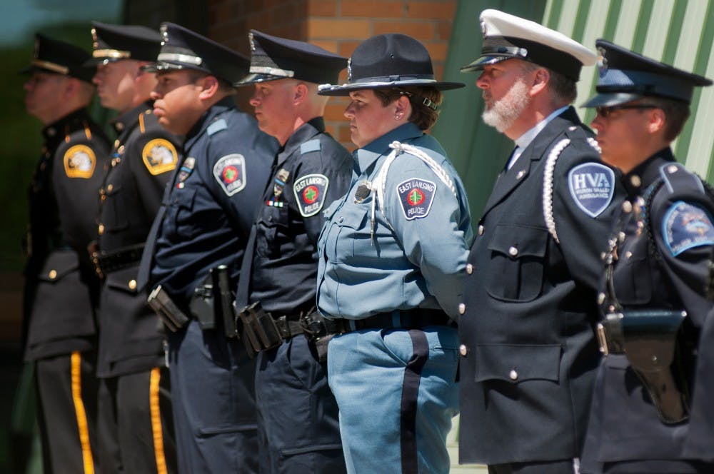 Officers and firefighters stand in line outside St. Thomas Aquinas Parish, 955 Alton Road, on May 11, 2012 for a mock funeral service honoring Deputy Paul Cole who died in the line of duty in 1996. The service acted as practice for members of the Honor Guard who dedicate their time to honor fallen officers. Julia Nagy/The State News