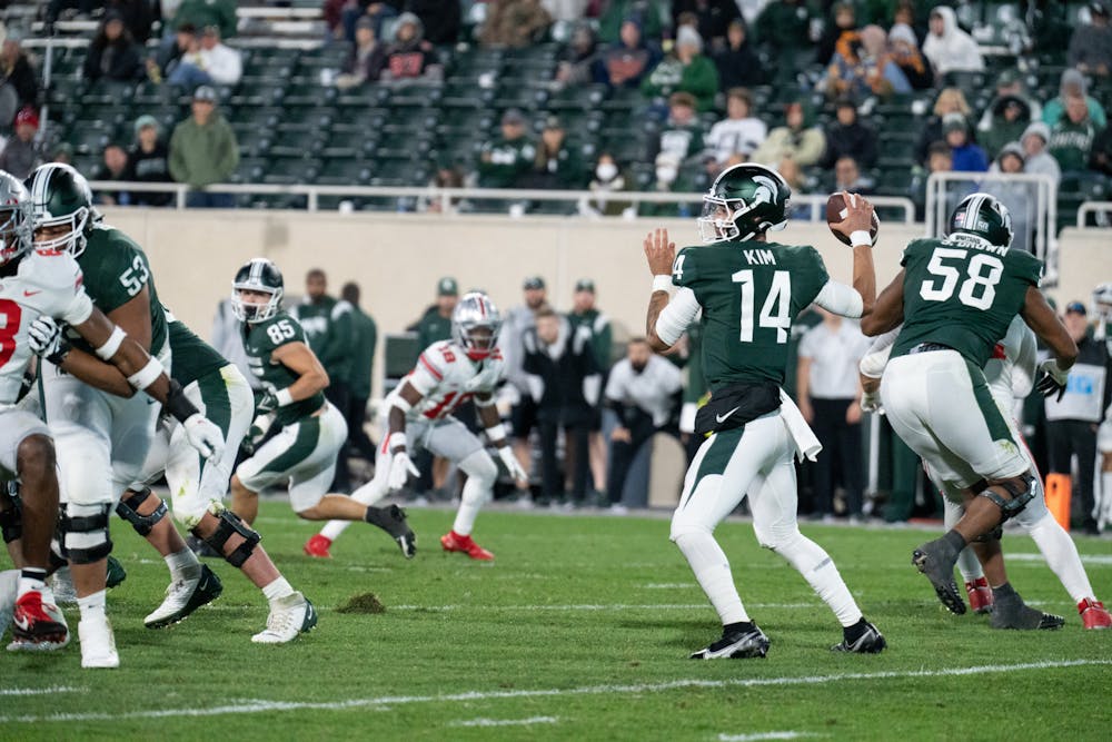 <p>Redshirt sophomore quarterback Noah Kim, 14, throws a pass during the match against Ohio State on Oct. 8, 2022.﻿</p>