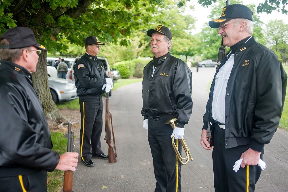 	<p>From right, <span class="caps">VFW</span> Post 701 honor guard members Kevin Kelley and Don Manker chat with other guard members, May 27, 2013, at Chapel Hill Memorial Gardens, of 4444 W. Grand River Ave., in Lansing, before the Memorial Day service. The <span class="caps">VFW</span> Post 701 is the oldest in the Lansing area. Justin Wan/The State News</p>