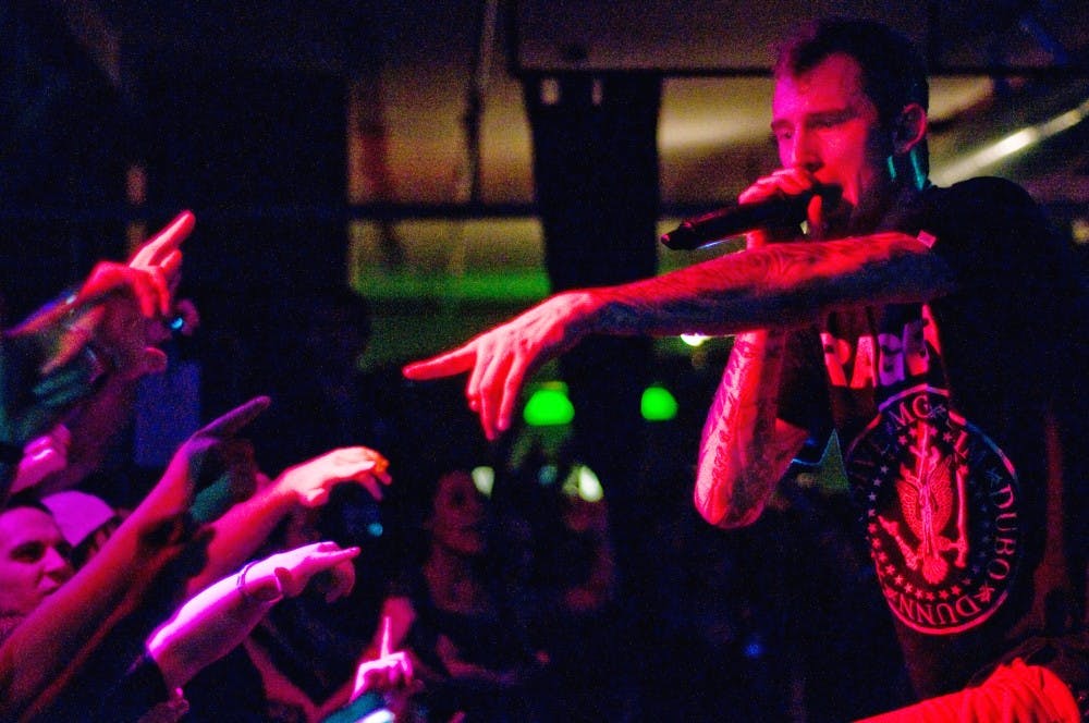 Shaker Heights, OH rapper Machine Gun Kelly points into the crowd while performing. Kelly performed Saturday for an excited crowd at the Loft in Lansing. Anthony Thibodeau/The State News