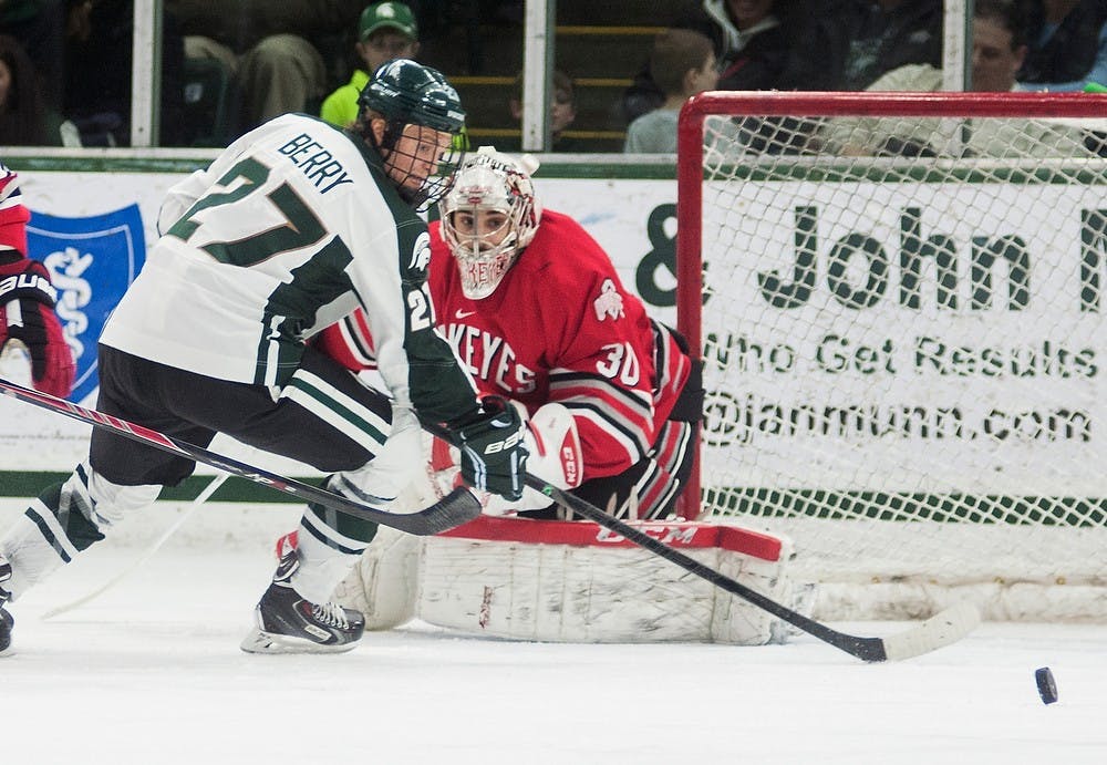 <p>Junior forward Matt Berry looks after the puck as it slides in front of Ohio State goaltender Christian Frey on Feb. 7, 2014, at Munn Ice Arena. MSU plays Ohio State in the Big Ten Tournament on Thursday. Danyelle Morrow/The State News</p>