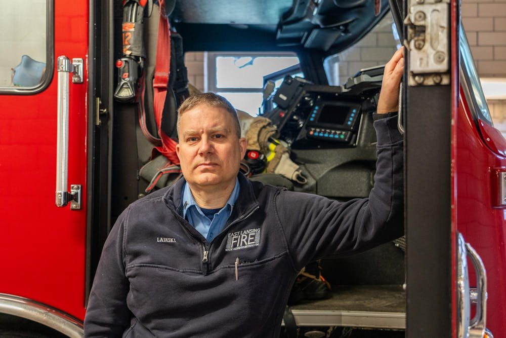 East Lansing Fire Department Captain James Lidiski poses next to a firetruck at the Department's on-campus station on Friday, Feb.2, 2023. Lidiski was a first responder on the night of the Feb. 13, 2023 shooting on MSU's campus, and helped block roadways and search for victims.