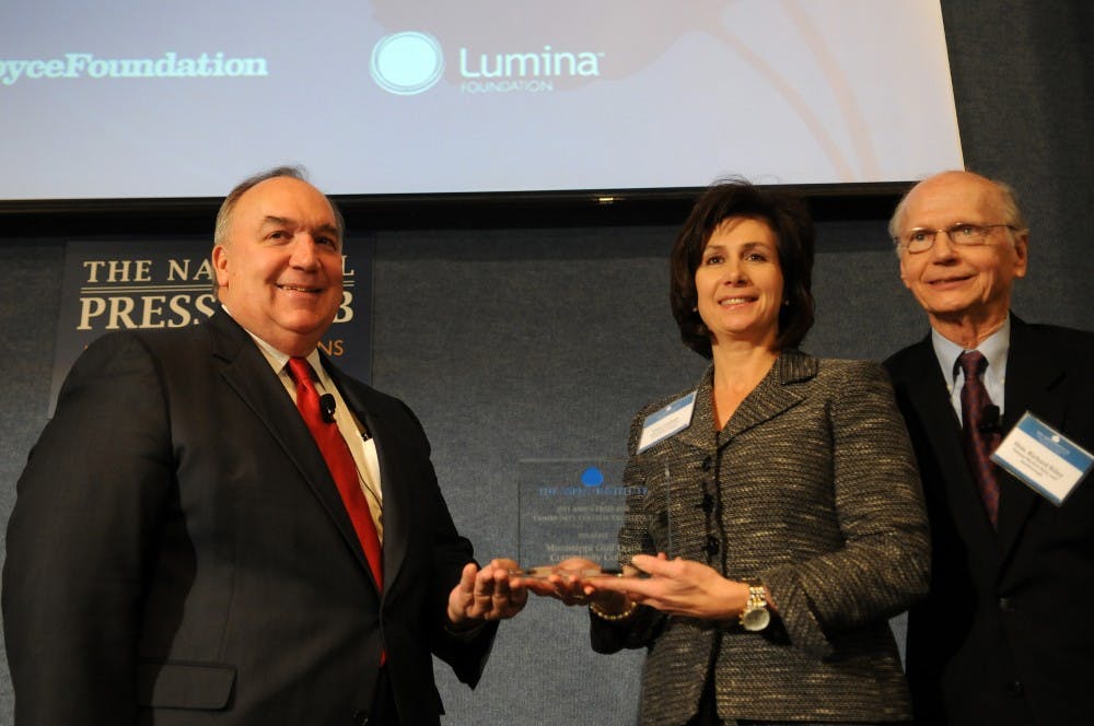Mary Graham of the Mississippi Gulf Coast Community College receives one of the awards from Richard Riley, former secretary of education, and John Engler, left, former Michigan Governor, during the award ceremony of the nation's first annual winner of the Aspen Prize for Community College Excellence at the National Press Club in Washington, D.C., Monday, December 12, 2011. (Astrid Riecken/MCT) 