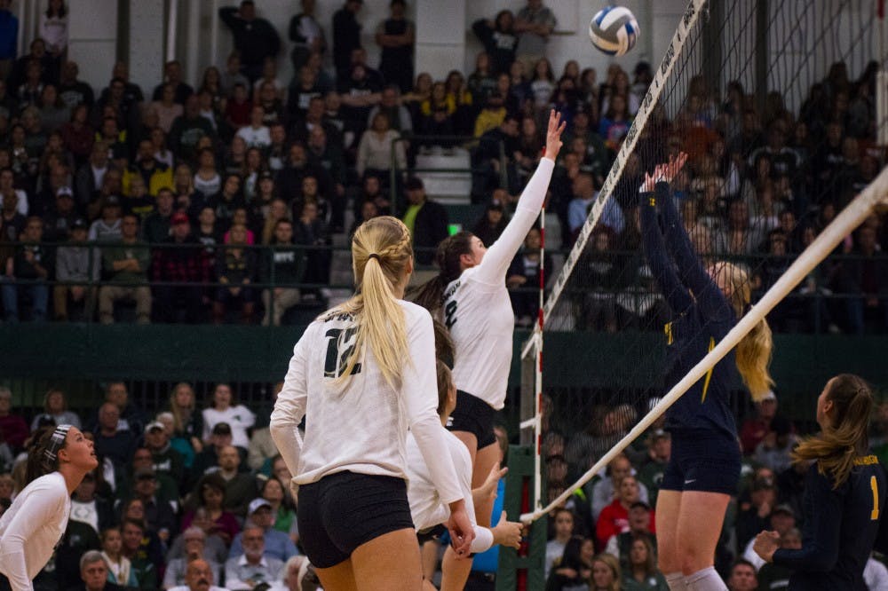 Junior outside hitter Autumn Bailey (2) hit the ball over the net during the game against Michigan on Nov. 12, 2016 at Jenison Fieldhouse. The Spartans defeated the Wolverines, 3-1. 
