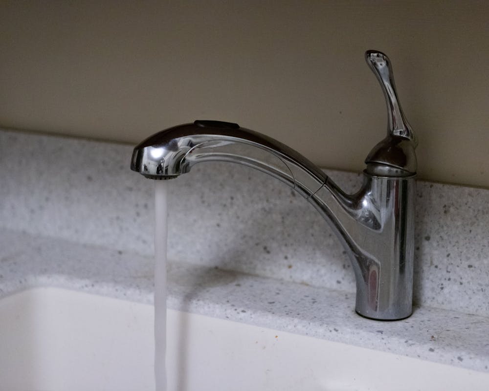 <p>Clean water runs from a kitchen faucet on Feb.15, 2022.</p>