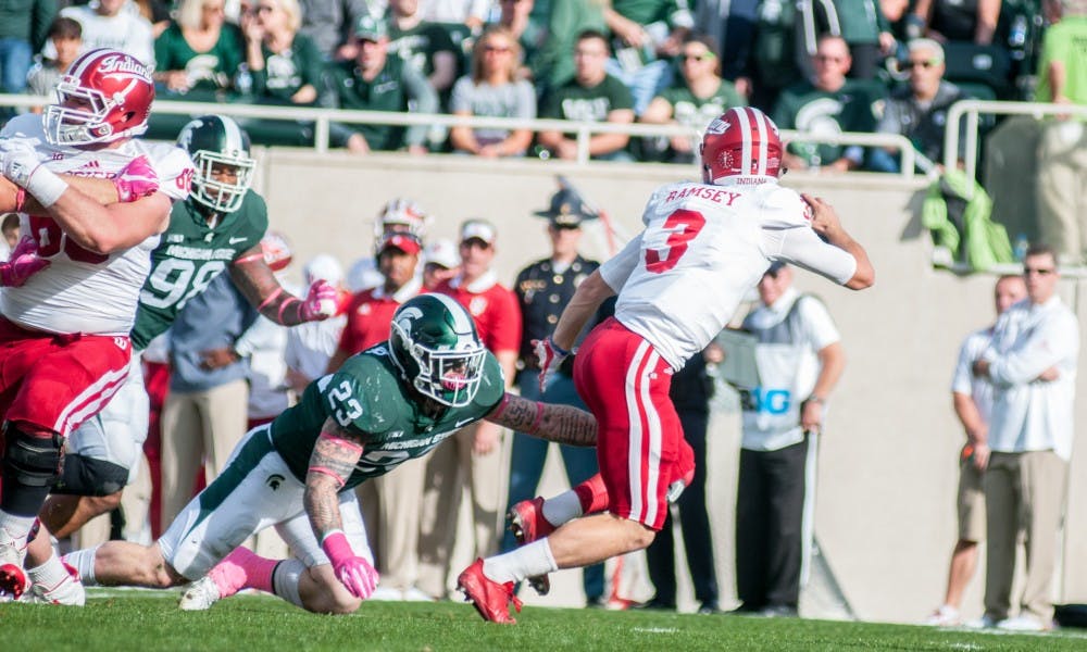 <p>Senior linebacker Chris Frey (23) dives at Indiana quarterback Peyton Ramsey (3) during the game against Indiana on Oct. 21, 2017, at Spartan Stadium. The Spartans defeated the Hoosiers, 17-9.</p>