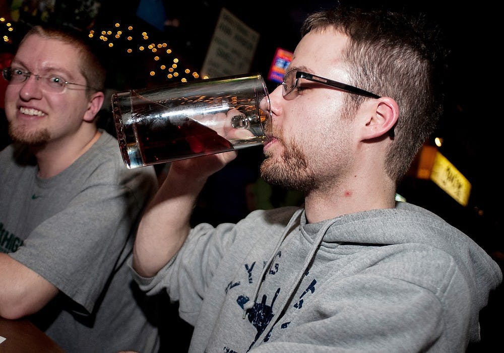 	<p>Criminal justice sophomore at Lansing Community College Martin Peterson, right, drinks Bell&#8217;s beer with Morrice, Mich., resident David Kubala on Sunday, March 24, 2013, at Crunchy&#8217;s, 254 W. Grand River Ave. There was a tapping at midnight of Bell&#8217;s Oberon beer. </p>