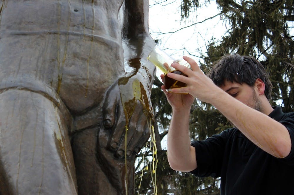 	<p><span class="caps">MSU</span> graduate student Jefferson Kielwagen anoints the Sparty statue on March 7. Photo courtesy of Jefferson Kielwagen</p>