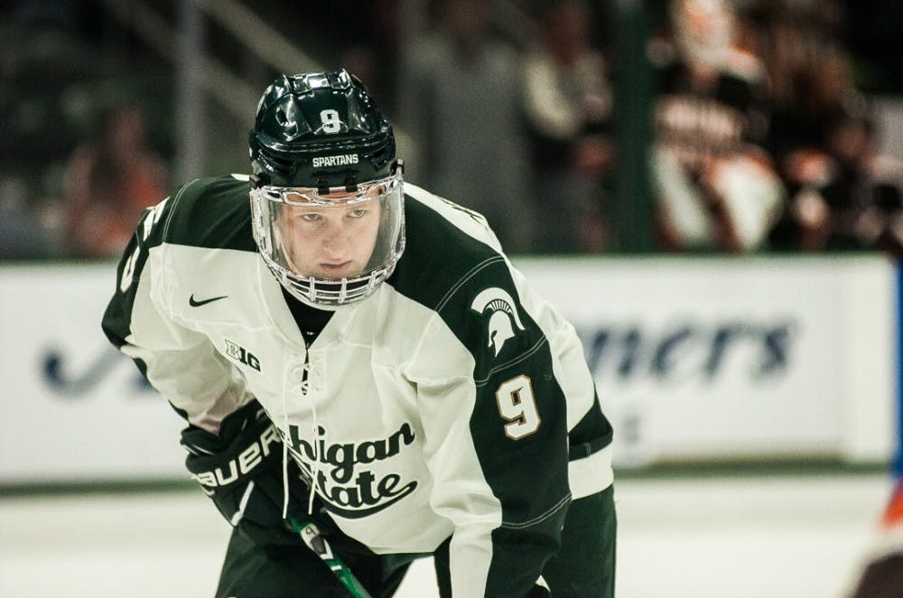 Freshman forward Mitchell Lewandowski (9) watches the puck during the game on Oct. 14, 2017 at Munn Ice Arena. The Spartans defeated the Falcons 3-2 with seconds left in the game. 