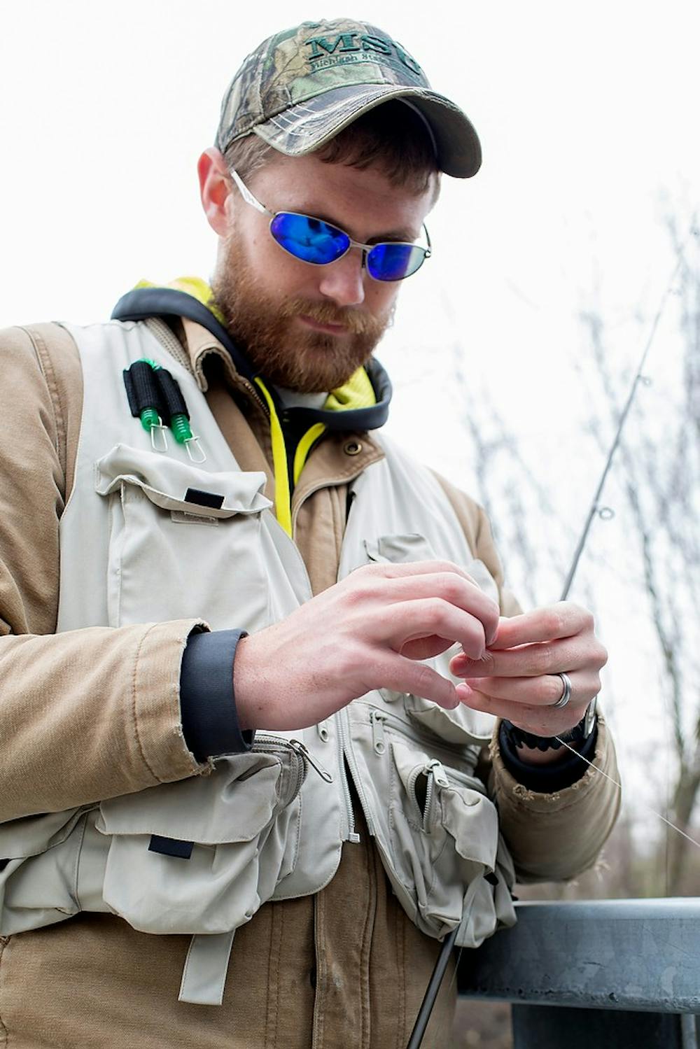 	<p>Graduate student Brandon Armstrong prepares to fish in the newly stocked Red Cedar River on Monday on the west side of campus. The Michigan Department of Natural Resources released more than 3,000 fish into the river. Natalie Kolb/The State News</p>