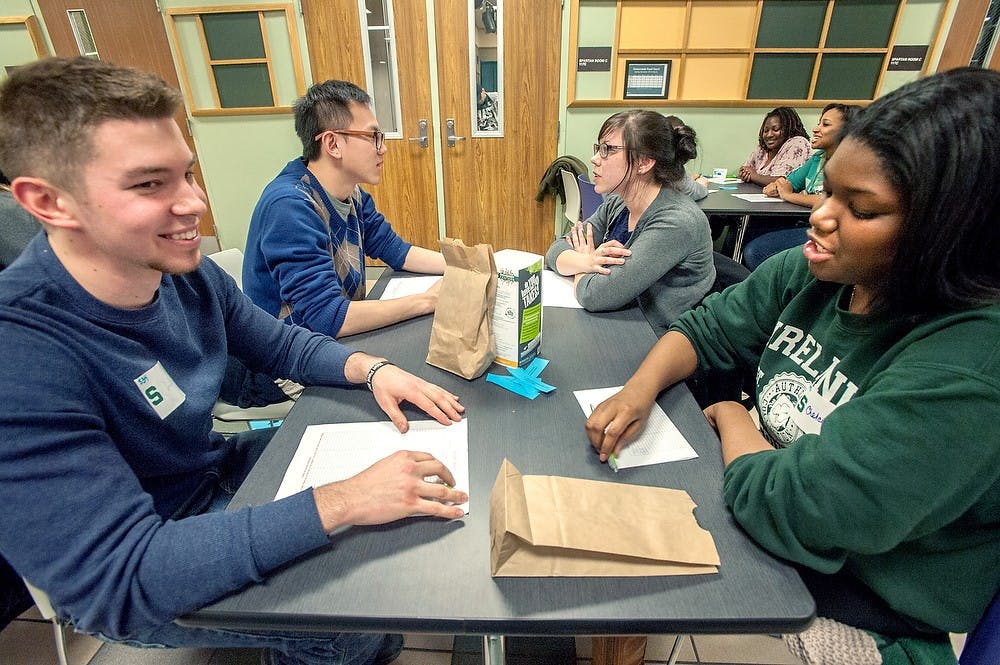 <p>Then-civil engineering junior Jacob Stepp, far left, talks with then-James Madison freshman Chelcie Gilliard, far right, Feb. 2, 2013, at International Center during the speed dating hosted by the University Activity Board. State News File Photo</p>