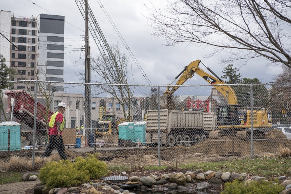 <p>Constructions workers work at the Park District project in East Lansing on April 12, 2019. (Nic Antaya/The State News)</p>