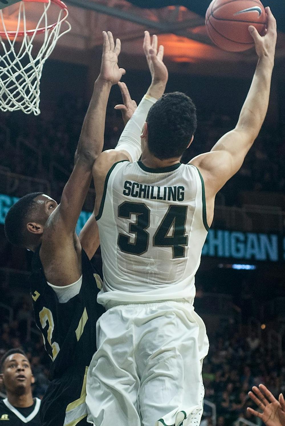 <p>Sophomore forward Gavin Schilling goes up for a layup against Arkansas-Pine Bluff guard/forward JoVaughn Love on Dec. 6, 2014, at Breslin Center. The Spartans defeated the Golden Lions, 85-52. Aerika Williams/The State News </p>