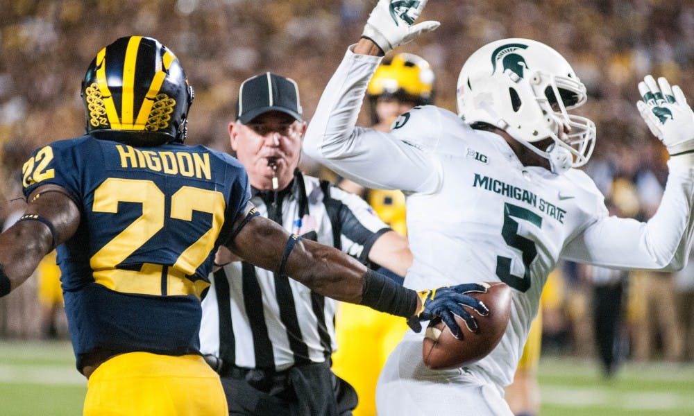 <p>Junior linebacker Andrew Dowell (5) collides with Michigan running back Karan Higdon (22) during the game against University of Michigan on Oct. 7, 2017, at Michigan Stadium. The Spartans defeated the Wolverines 14-10.</p>