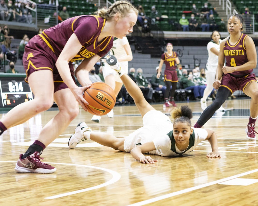 <p>Freshman guard Deedee Hagemann loses control of the ball, and it is recovered by Minnesota graduate student forward Laura Bagwell-Katalinich on Jan. 23, 2022.</p>