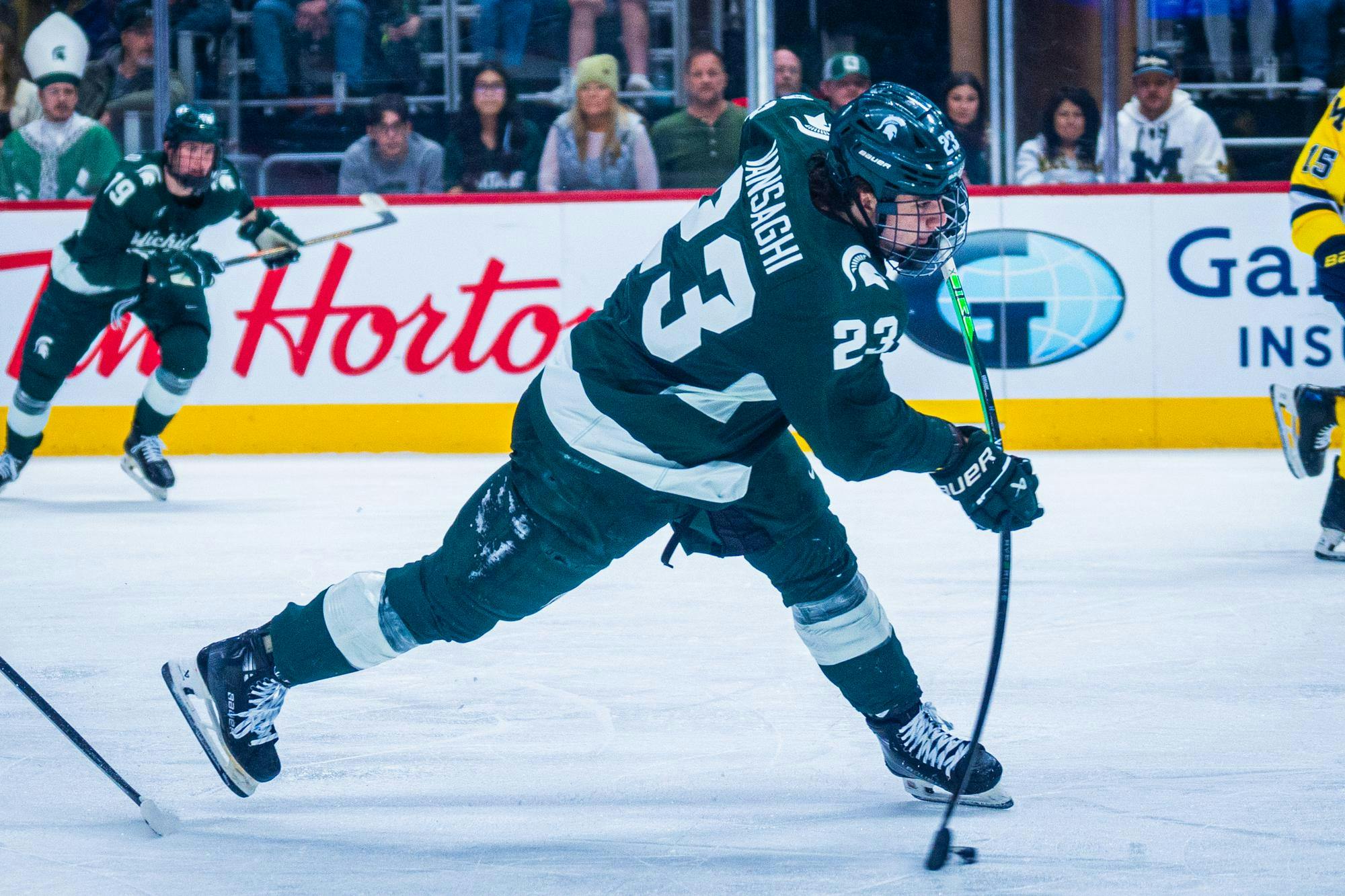 MSU freshman forward Shane Vansaghi (23) attempts a slap shot during a match at Little Caesars Arena on Feb. 8, 2025.