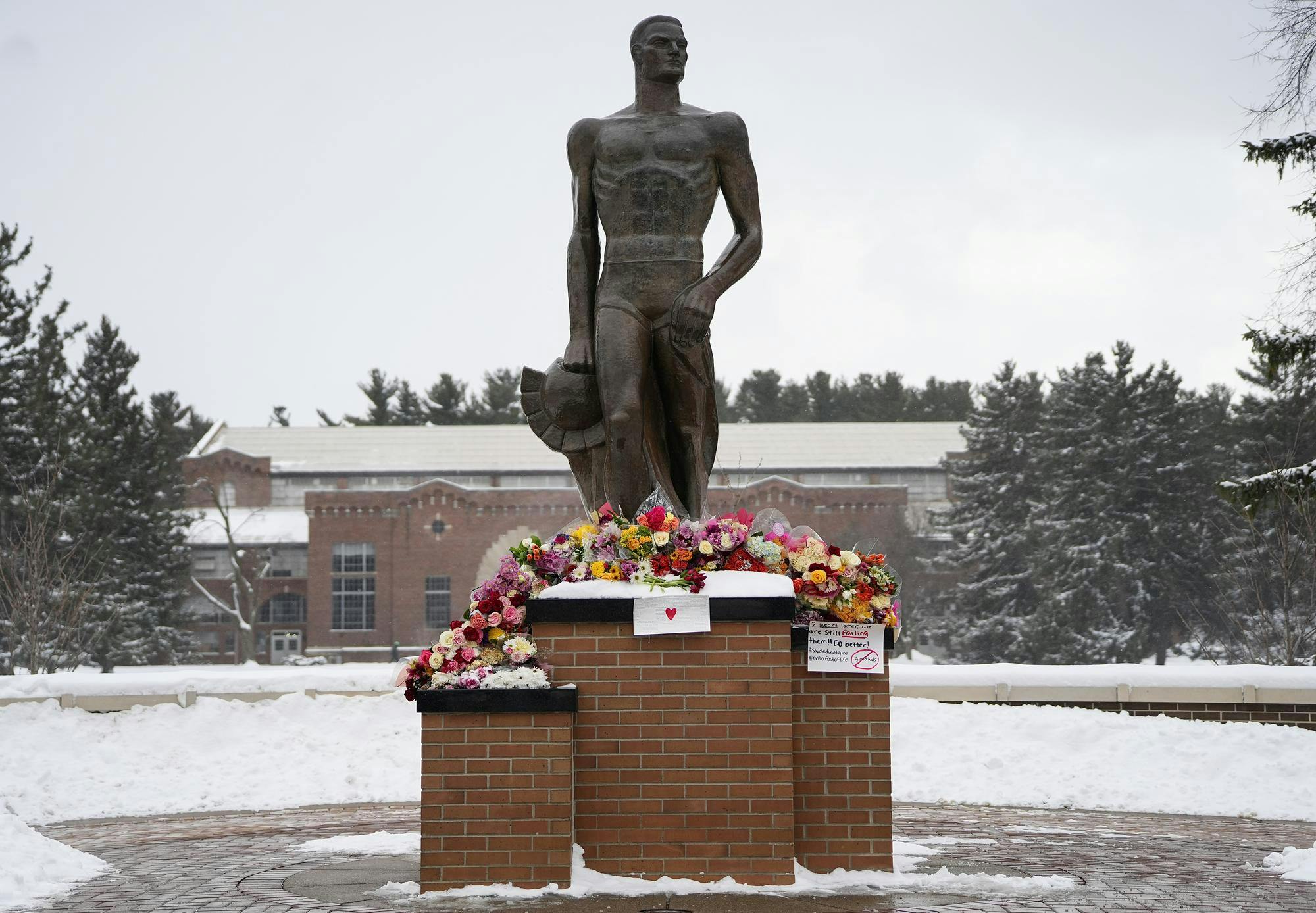 The Spartan Statue is piled with flowers in honor of the three victims of the MSU shooting on Feb. 13, 2025. 