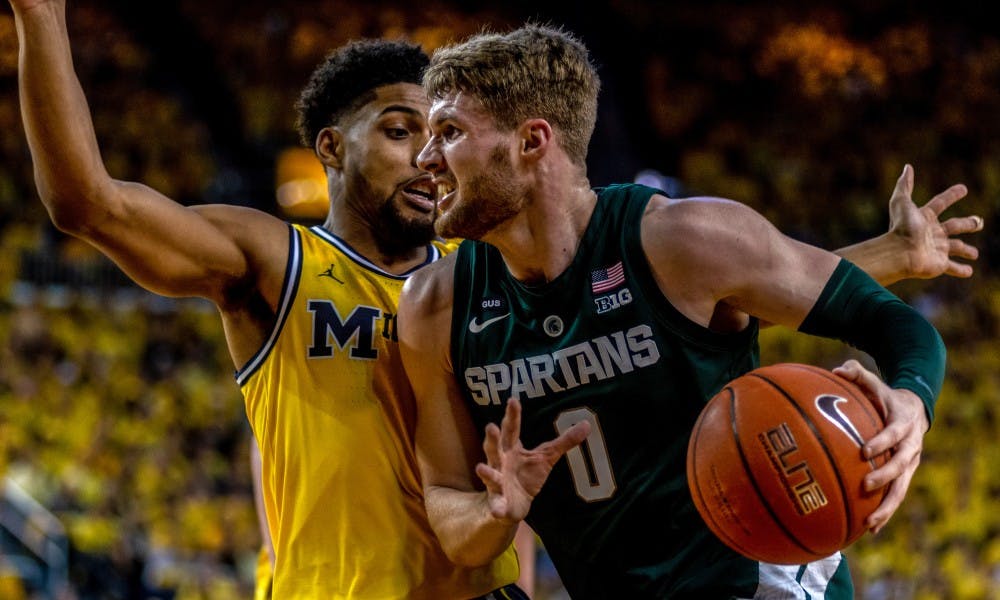 <p>Senior forward Kyle Ahrens (0) drives for a layup against Michigan. The Spartans beat the Wolverines, 77-70, on Feb. 24, 2019 at the Crisler Center.</p>
