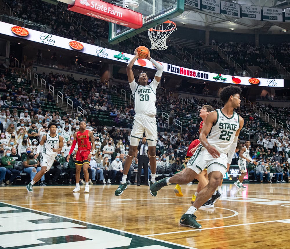 <p>Michigan State&#x27;s senior forward Marcus Bingham Jr. (30) jumps to dunk the ball during Michigan State&#x27;s victory over Ferris State on Oct. 27, 2021</p>