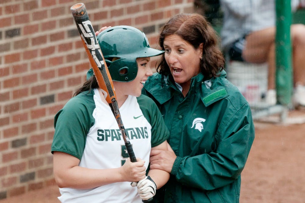 Senior right fielder Melanie Bensema, left, chats with head coach Jacquie Joseph during Saturday's game at Secchia Stadium at Old College Field against Indiana. The Spartans lost each game in Saturday's doubleheader by a score of 6-5. Julia Nagy/The State News