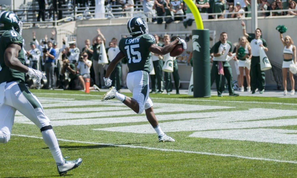 <p>Junior cornerback Tyson Smith (15) returns an interception for a touchdown during the game against Bowling Green on Sep. 2, 2017, at Spartan Stadium. The Spartans defeated the Falcons, 35-10.</p>