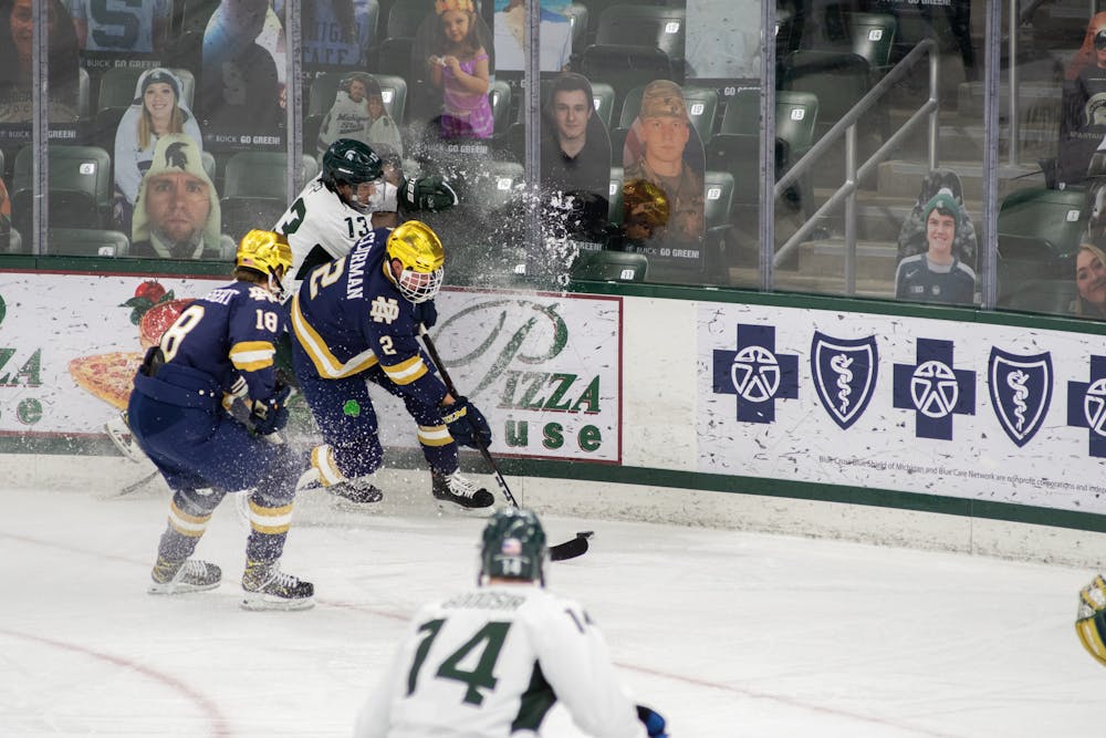<p>Notre Dame&#x27;s Nate Clurman (2) and Graham Slaggert (18) pin Michigan State&#x27;s Kristof Papp (13) during the Spartans&#x27; loss to Notre Dame on Feb. 26, 2021.</p>