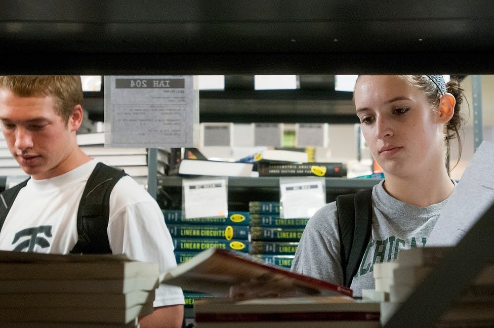 	<p>Accounting sophomore Tyler Smith and hospitality business junior Jackie Gustin shop for textbooks, Aug. 29, 2013, at College Textbook Company, 321 E. Grand River Ave. Khoa Nguyen/ The State News</p>