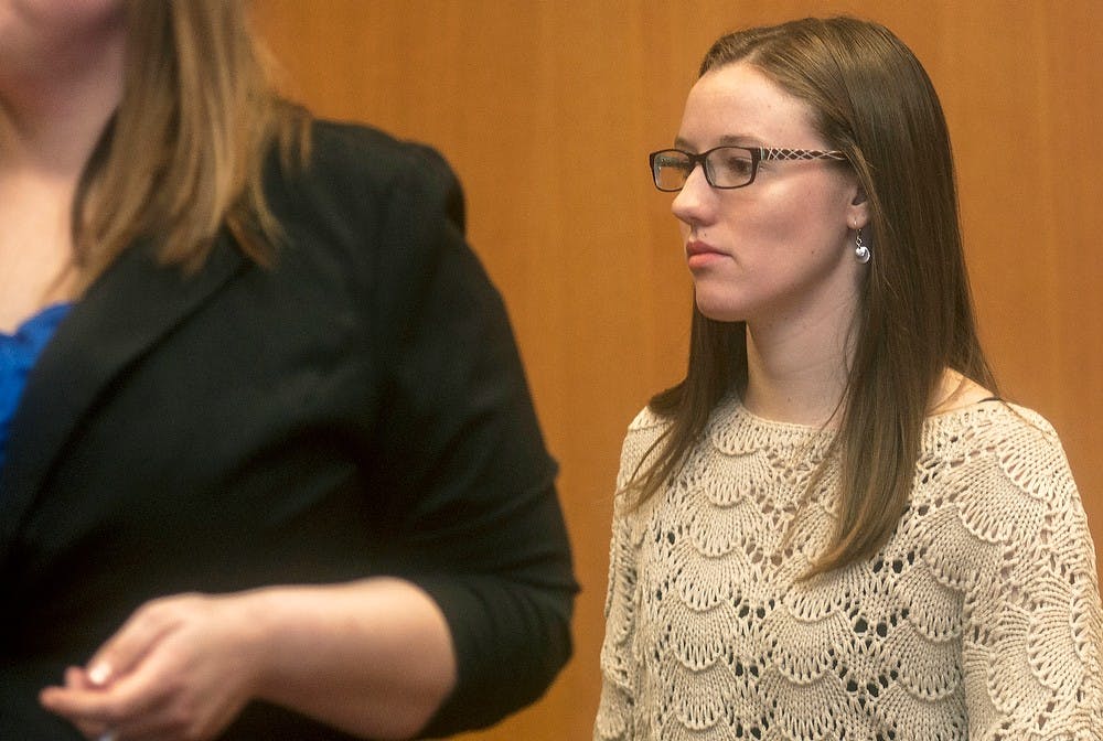 	<p>Music education senior Maura McGlynn walks into the court room for her preliminary exam Feb. 10, 2014, at 54B District Court, 101 Linden St. McGlynn received a lesser charge of a littering civil infraction. Erin Hampton/The State News</p>