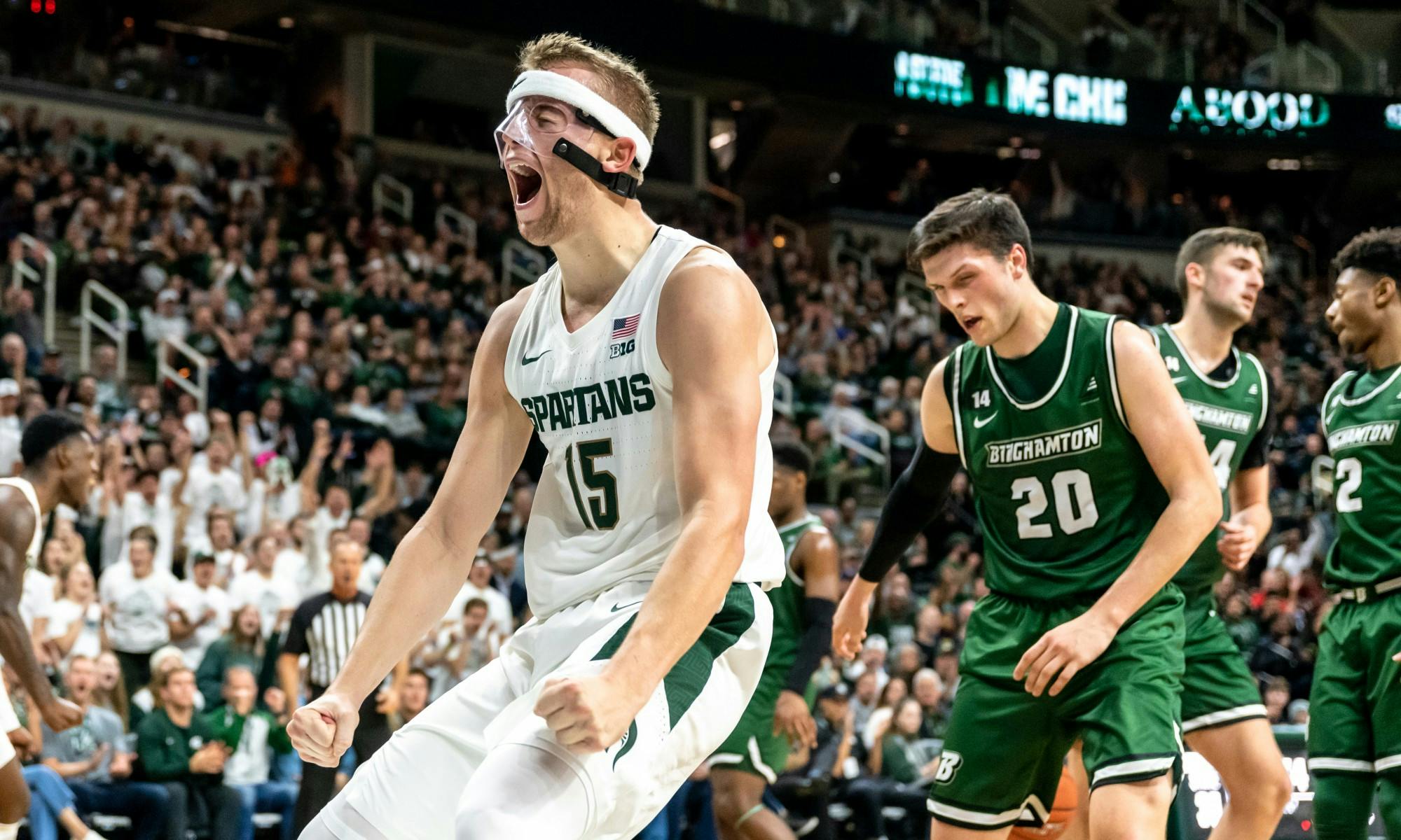 <p>Junior forward Thomas Kithier (15) celebrates after a dunk against Binghamton. The Spartans defeated the Bearcats 100-47 at the Breslin Student Events Center on Nov. 10, 2019. </p>