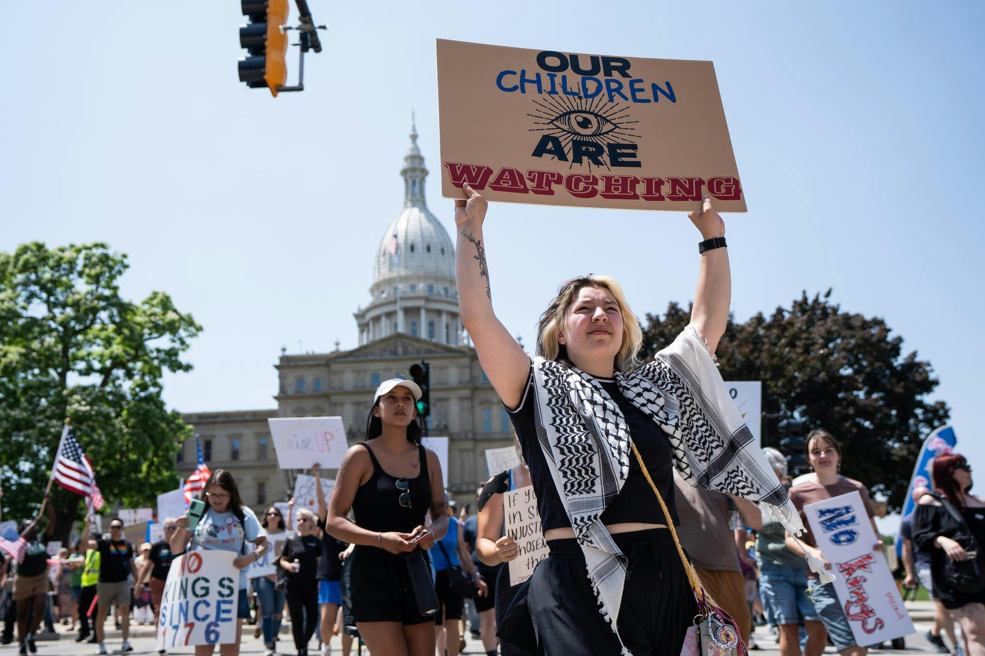 <p>Protesters begin marching away from the Michigan Capitol during the 'No Kings' protest on June 14, 2025.</p>