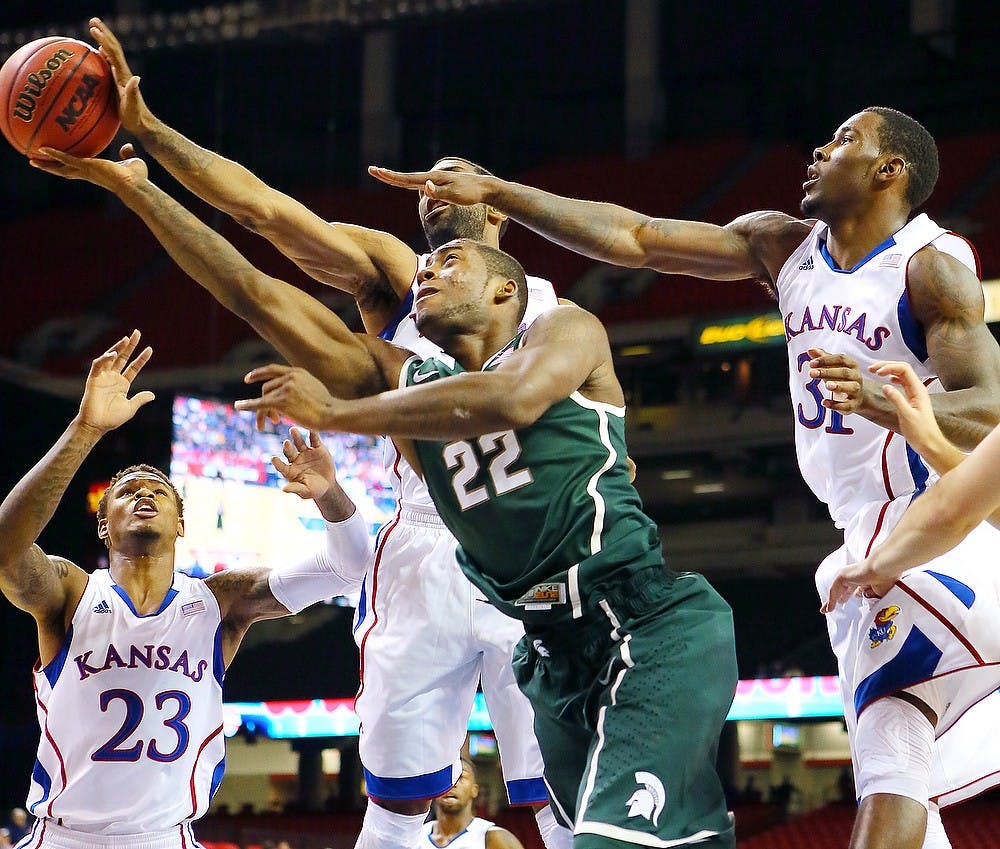 	<p>Michigan State&#8217;s sophomore forward/guard Branden Dawson (22) is triple-teamed by Kansas defenders, from left, Ben McLemore, Justin Wesley and Jamari Trayor on his way to the basket during first-half action in the State Farm Champions classic at the Georgia Dome on Tuesday, November 13, 2012, in Atlanta, Georgia. Curtis Compton/Atlanta Journal-Constitution/MCT</p>