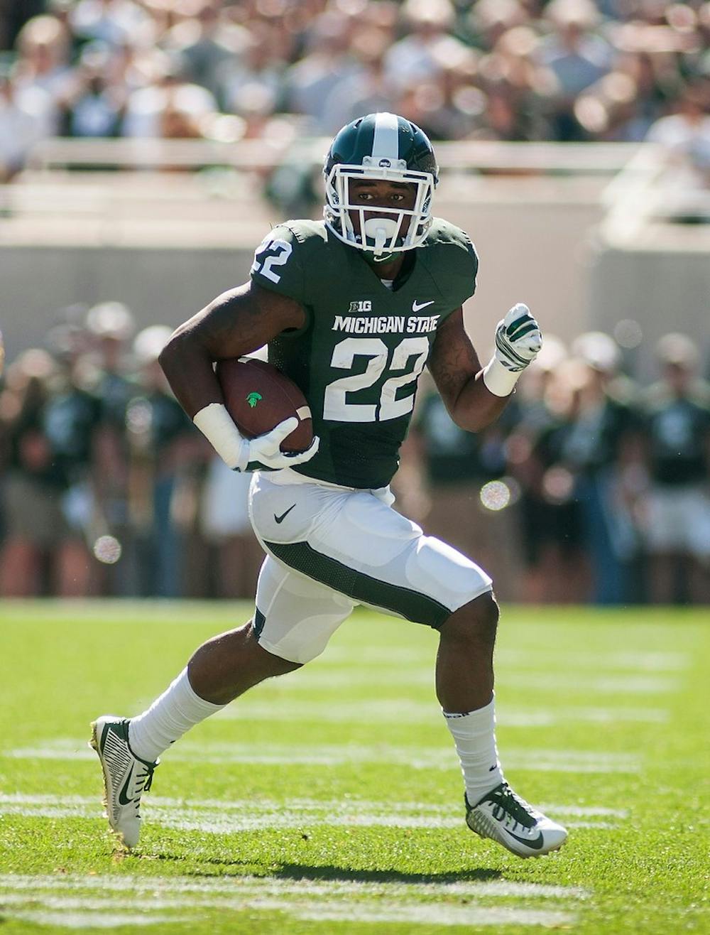 <p>Sophomore running back Delton Williams runs down the field during the game against Wyoming on Sept. 27, 2014, at Spartan Stadium. The Spartans defeated the Cowboys, 56-14. Raymond Williams/The State News</p>