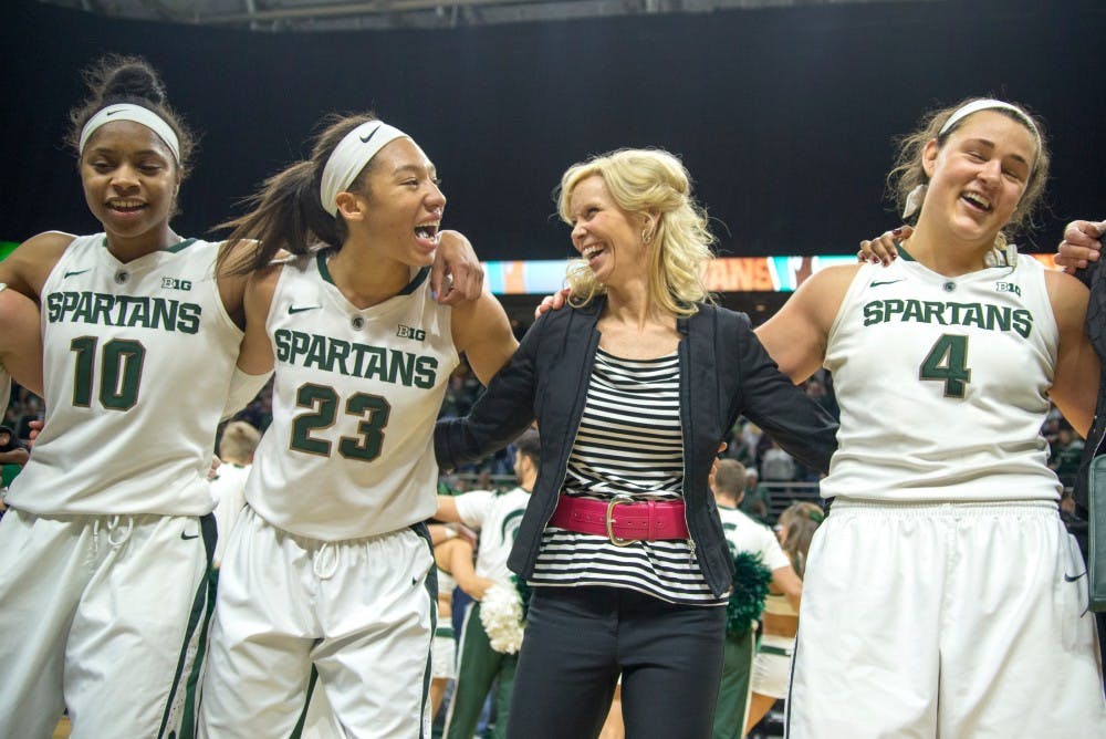From left to right, sophomore guard Branndais Agee, junior forward Aerial Powers, head coach Suzy Merchant and senior center Jasmine Hines celebrate their teams victory after the game against Ohio State on Feb. 27, 2016 at Breslin Center. The Spartans defeated the Buckeyes, 107-105 in triple overtime.