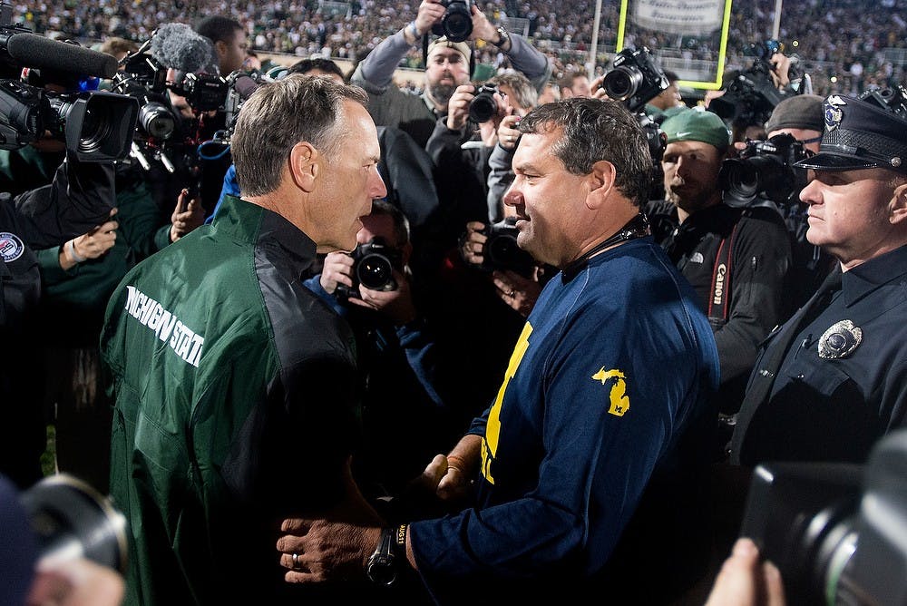 <p>Head coach Mark Dantonio shakes Michigan head coach Brady Hoke's hand Oct. 25, 2014, after the game against Michigan at Spartan Stadium. The Spartans defeated the Wolverines, 35-11. Julia Nagy/The State News</p>