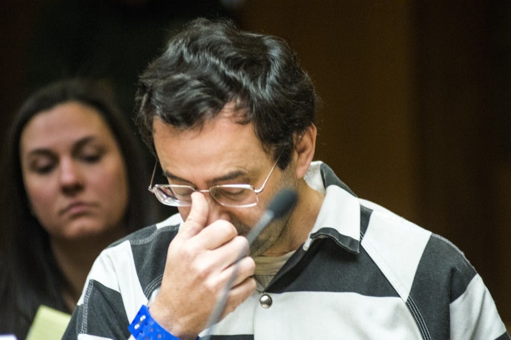 Former MSU employee Larry Nassar adjusts his glasses  before a pretrial hearing begins on Feb. 17, 2017 at 55th District Court in Mason, Mich. The hearing occurred as a result of former MSU employee Larry Nassar's alleged sexual abuse.