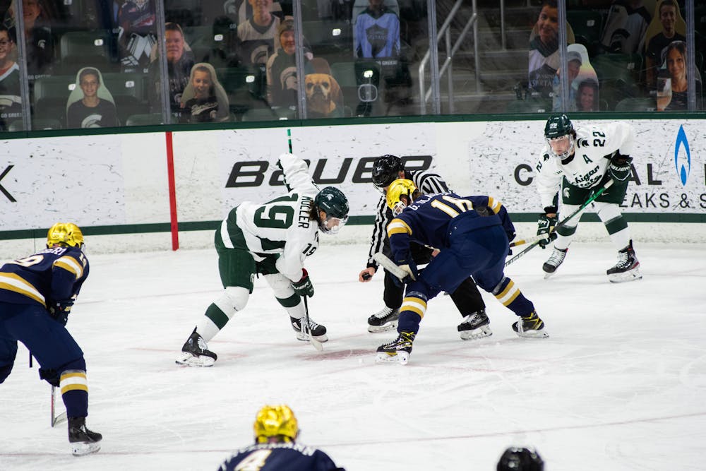 <p>Michigan State&#x27;s Nicolas Müller (19) faces off with Notre Dame&#x27;s Graham Slaggert (18) before the puck drop in the Spartans&#x27; loss against Notre Dame on Feb. 26, 2021.</p>