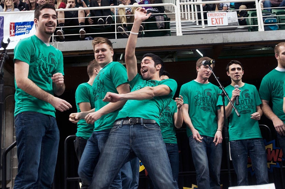 <p>Public Relations senior Lennon Kyriakoza performs with acapella group the Spartan Dischords during Relay for Life on March 28, 2014, at Breslin Center. The groups showed off both their singing and dancing skills. Allison Brooks/The State News</p>
