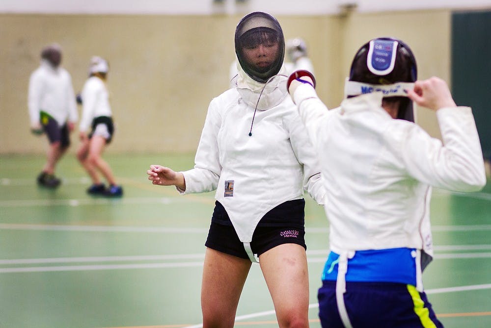	<p>Human biology senior Vanessa Marinas is poked by physics freshman Rebecca Brosig while warming-up during the <span class="caps">MSU</span> Fencing Club&#8217;s Wednesday practice. Simon Schuster/The State News</p>
