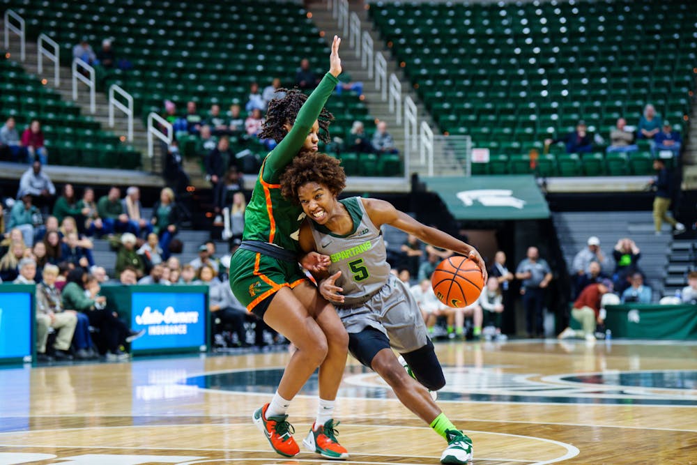 <p>Graduate Student guard Kamaria McDaniel drives through a defender during a matchup against Florida A&amp;M, held at the Breslin Center on Nov. 17, 2022. The Spartans defeated the Rattlers 109-44. </p>