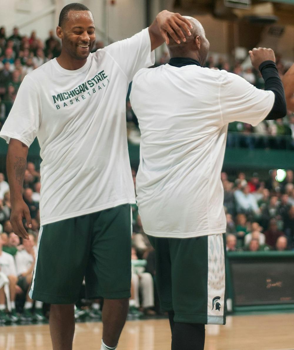 	<p>Former <span class="caps">MSU</span> forward Morris Peterson, left, pats teammate and former <span class="caps">MSU</span> guard Mateen Cleaves, right, on the head after Cleaves scored during the <span class="caps">MSU</span> men&#8217;s basketball alumni game Friday at Jenison Field House. Cleaves and Peterson were part of the White team, which won 125-118. Danyelle Morrow/The State News</p>
