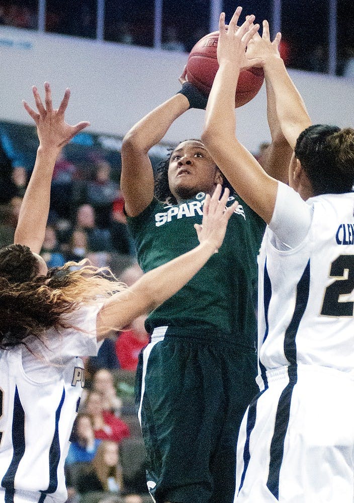 Senior guard Jasmine Thomas tries to shoot as Purdue guard K.K. Houser, 22, and forward Liza Clemons defend during the Big Ten Tournament championship game at Sears Centre in Hoffman Estates, Ill. The Spartans lost to the Boilermakers 62-47. Julia Nagy/The State News