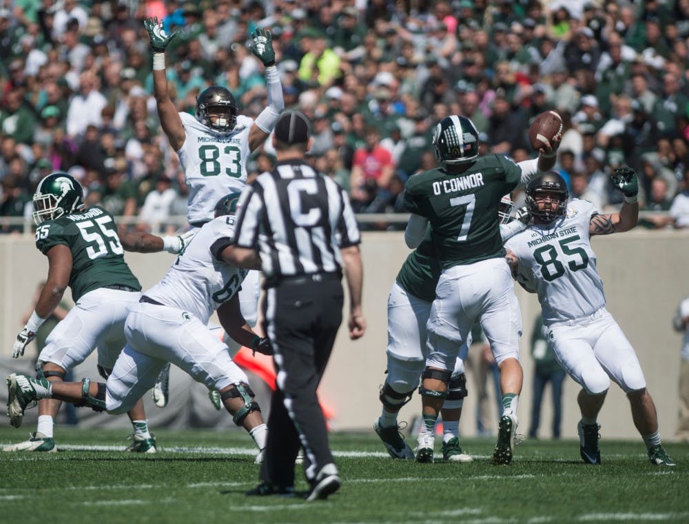 Senior quarterback Tyler O'Connor (7) goes to throw the football during the Green and White scrimmage on April 23, 2015 at Spartan Stadium. The White team defeated the Green team, 14-11.