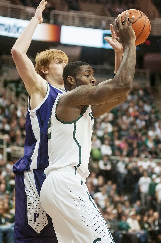 	<p>Junior guard/forward Branden Dawson looks to pass during the game against Portland on Nov. 18, 2013, at Breslin Center. The Spartans are leading at the half, 36-32. Danyelle Morrow/The State News</p>