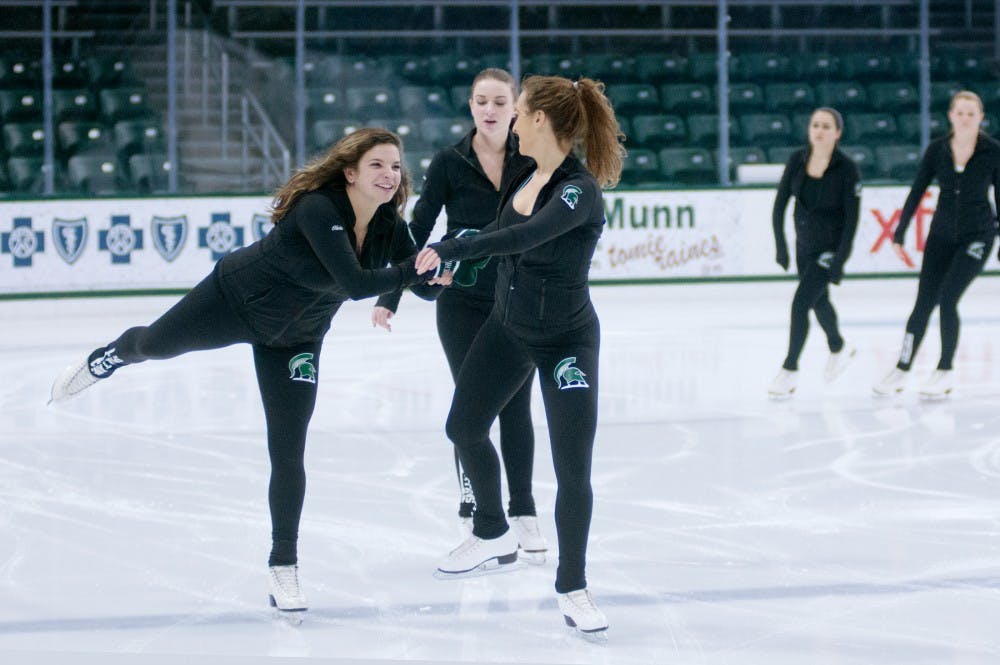 From left to right, kinesiology senior Olivia Dorantes, athletic training sophomore Lauren Jackson and hospitality business junior Meghan Erikson skate together while warming up for a MSU Figure Skating Club practice on Dec. 6, 2015 at Munn Ice Arena. The club is made up of girls of all levels who used to figure skate when they were younger and wish to continue the sport. 